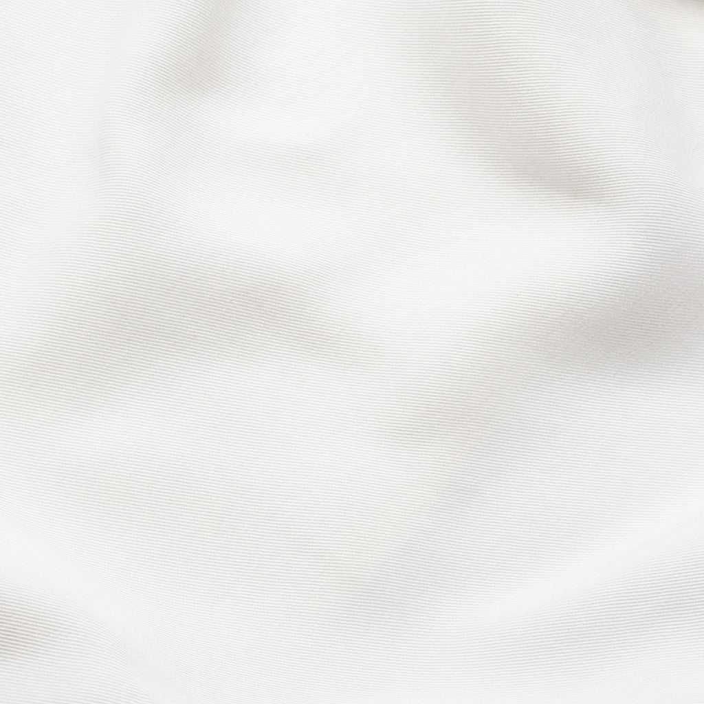 A close-up view of the Women's Cozy Earth Coastal Comfort Wrap Dress by Cozy Earth, showcasing its texture and subtle folds. The white fabric appears smooth and evenly lit, highlighting the fine details of the material's weave. |Color:White