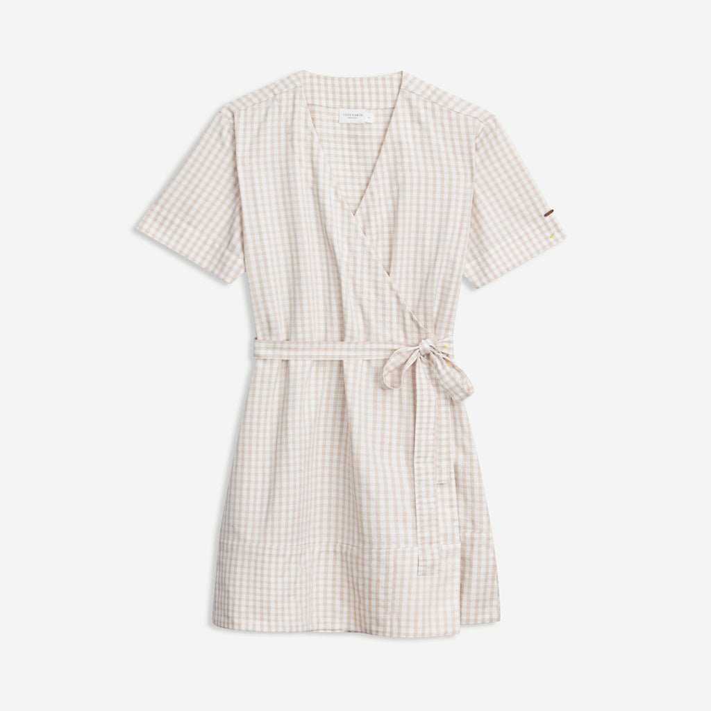 The Women's Cozy Earth Coastal Comfort Wrap Dress by Cozy Earth is a beige and white gingham wrap dress featuring short sleeves, a tie belt at the waist, a V-neckline, and a relaxed fit with a slightly flared hem. |Color:Sunkissed Gingham