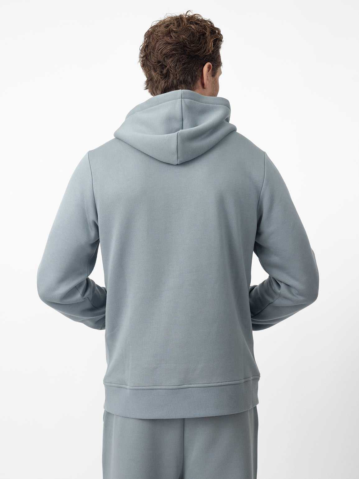 Back of man wearing smokey blue cityscape hoodie with white background |Color:Smokey Blue