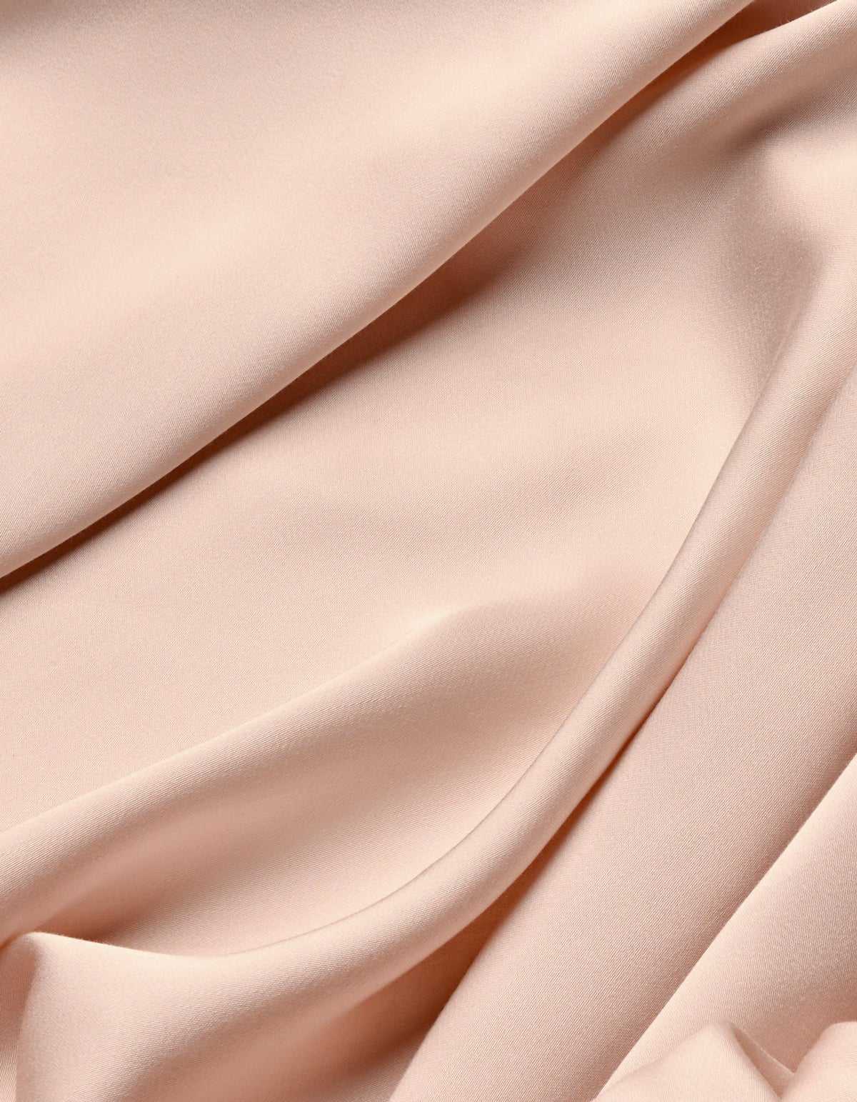 The Cozy Earth Bamboo Sheet Set features soft, light pink fabric with a smooth texture, gently draped to create subtle folds and shadows.|Color:Peony