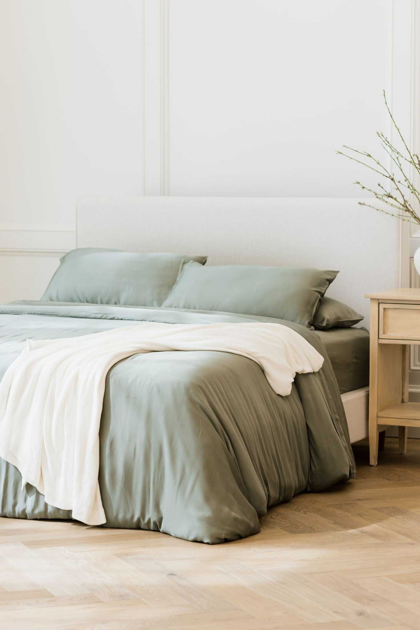 White cloud knit blanket draped over bed with sage bedding |Color:White