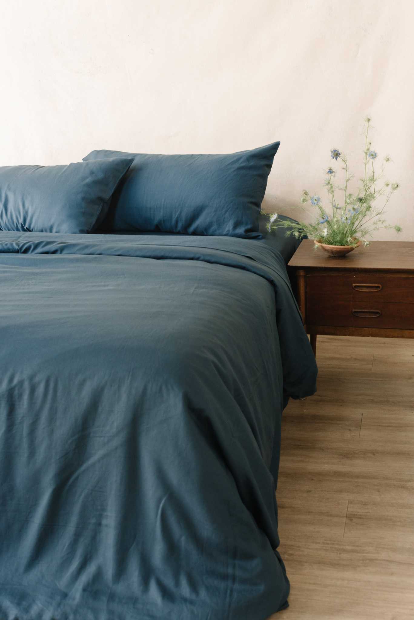 Navy Duvet Cover and comforter resting on a bed. |Color: Navy