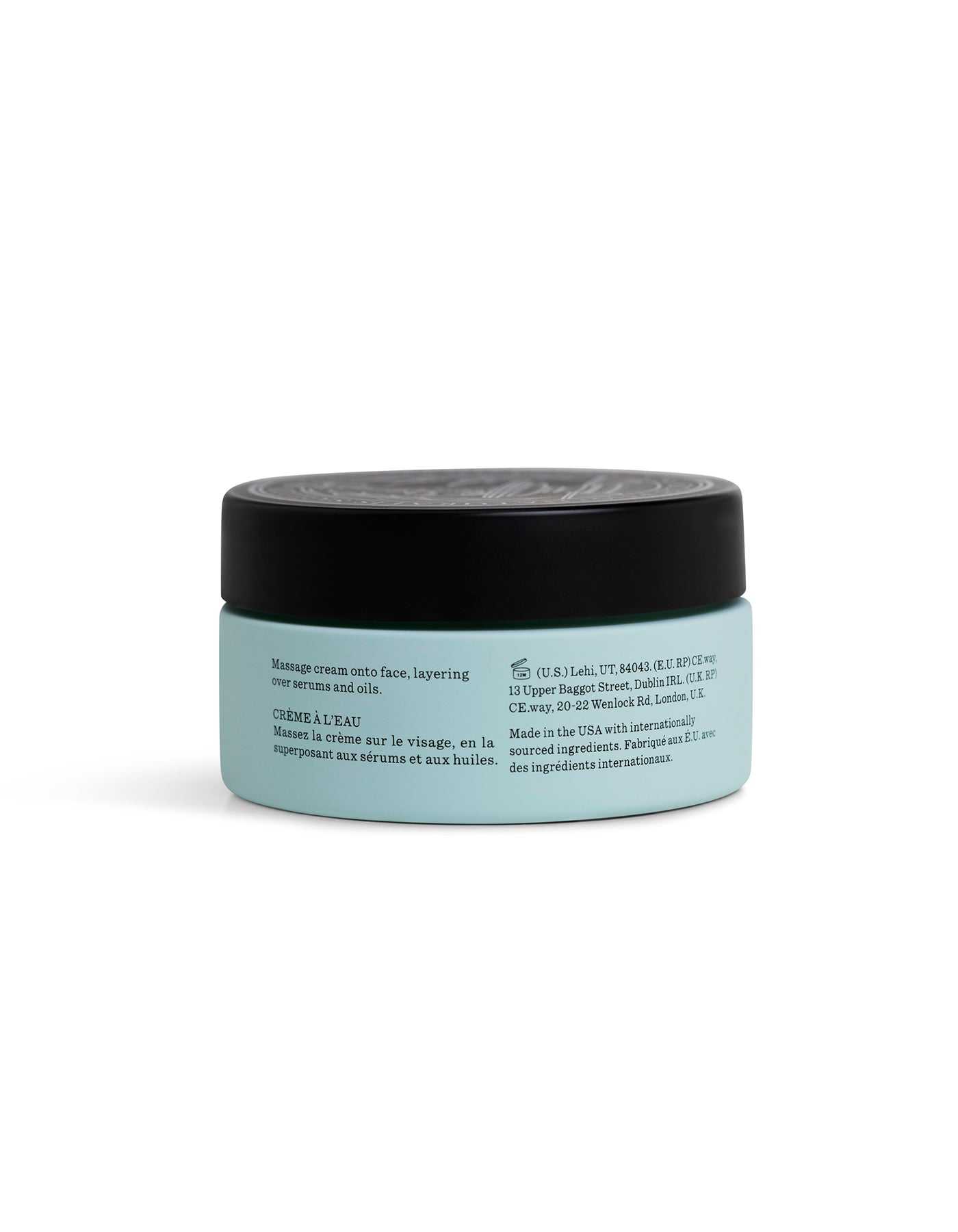 A light blue jar with a black lid contains Cozy Earth Water Cream Moisturizer. The label features product instructions and manufacturing details printed in English and French.