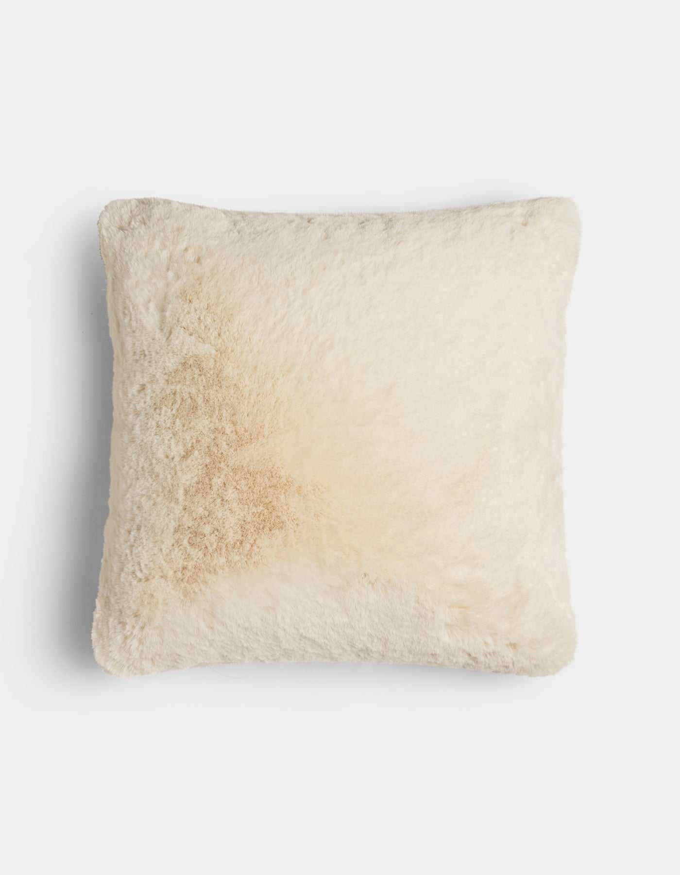 The Cuddle Pillow by Cozy Earth is a square, cream-colored, fluffy pillow featuring a light tan stain on the left side, shown against a plain white background.|Color:Creme