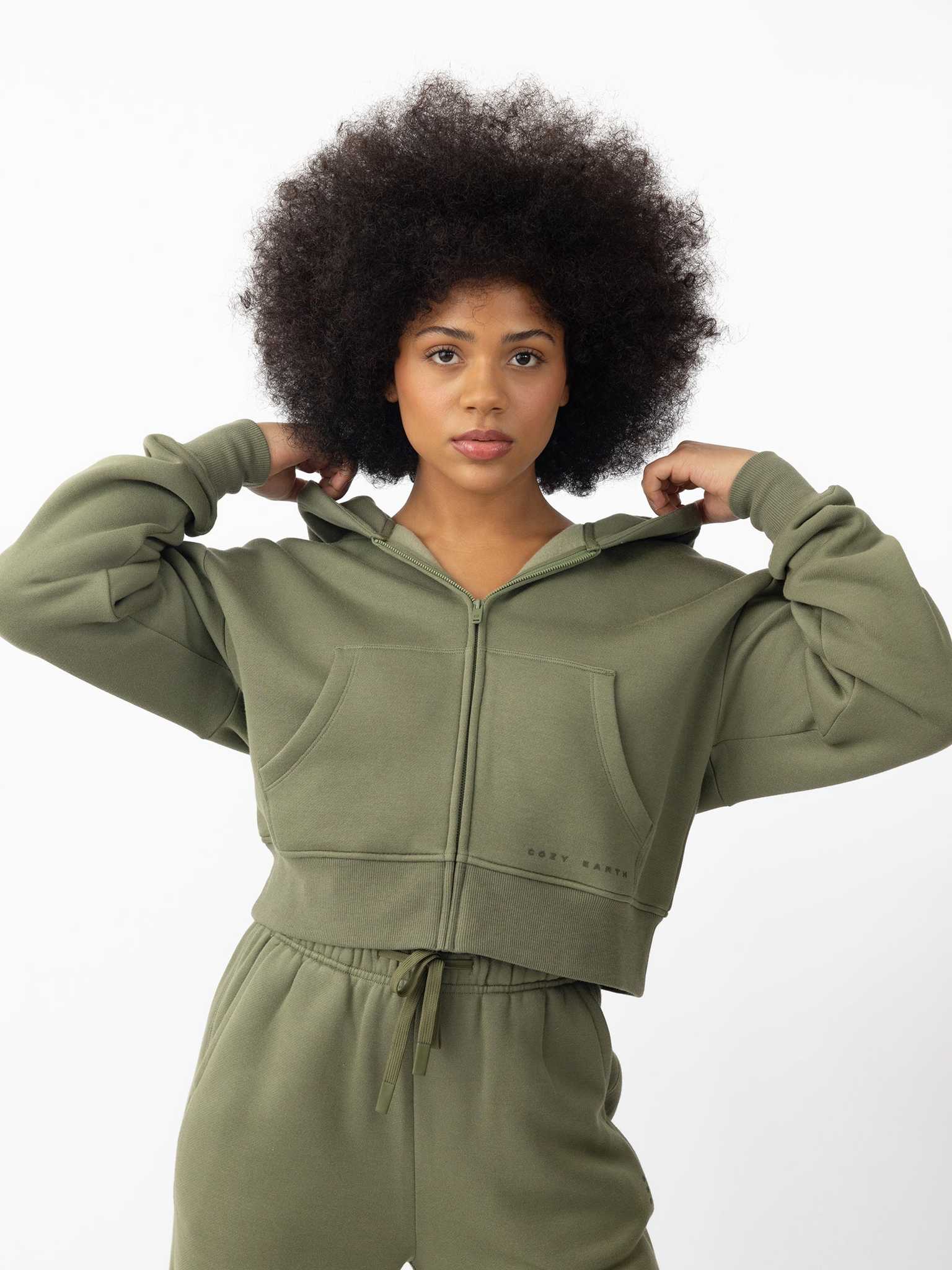 Woman wearing Juniper CityScape Cropped Full Zip with white background |Color: Juniper