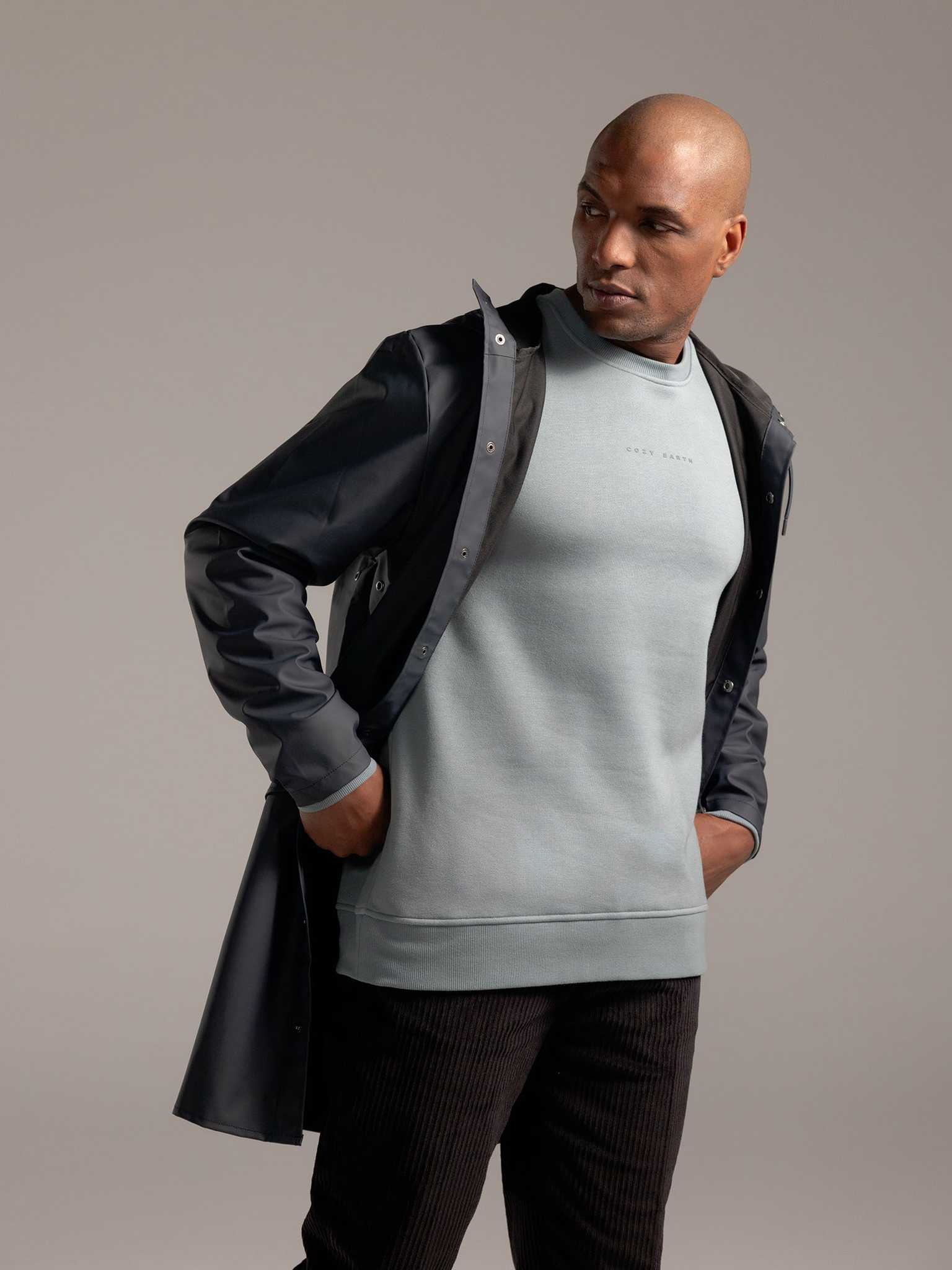 Man wearing Smokey Blue cityscape crewneck with grey background |Color:Smokey Blue