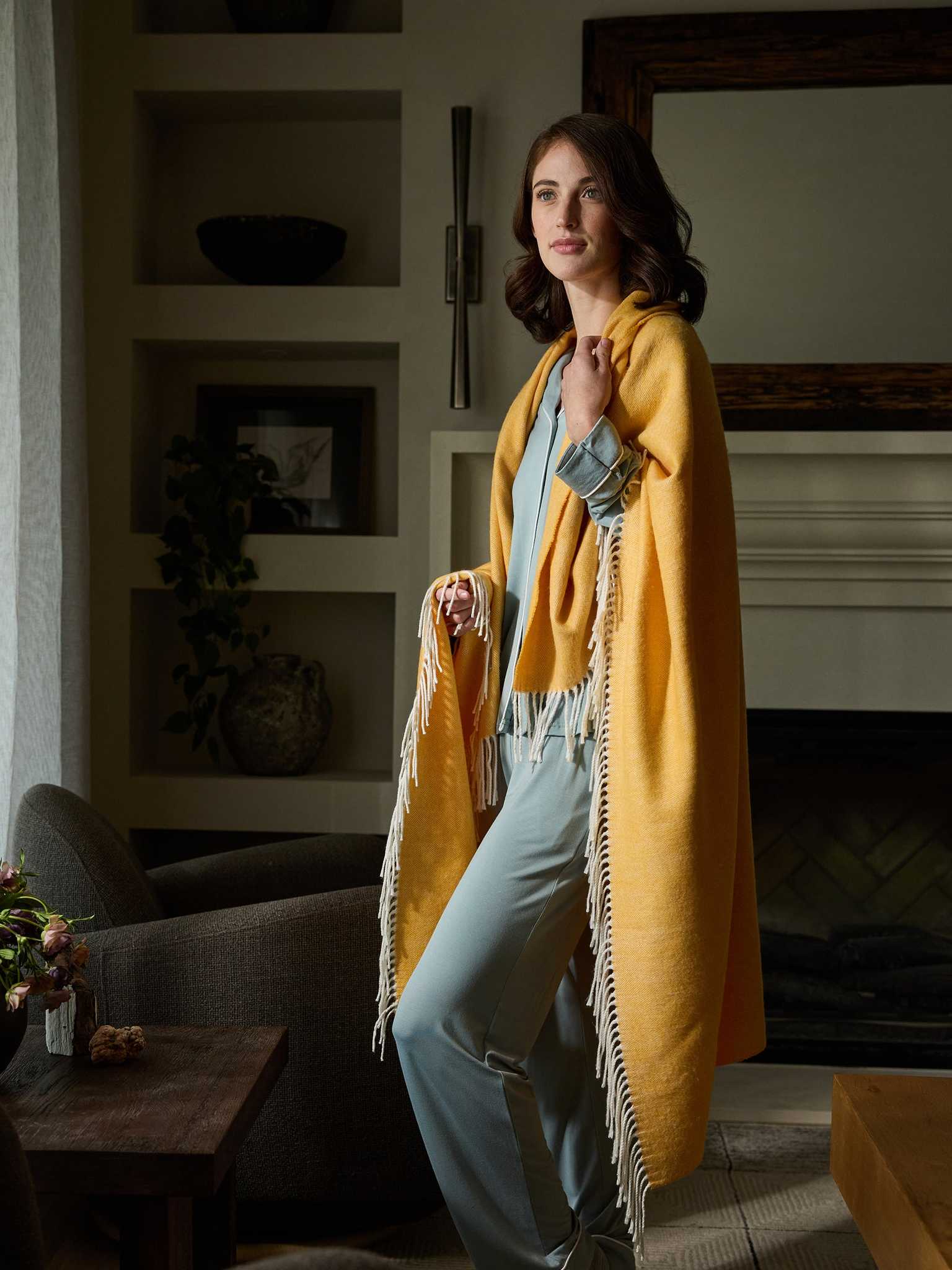 Woman standing with sunflower herringbone tassel throw wrapped around her |Color:Sunflower