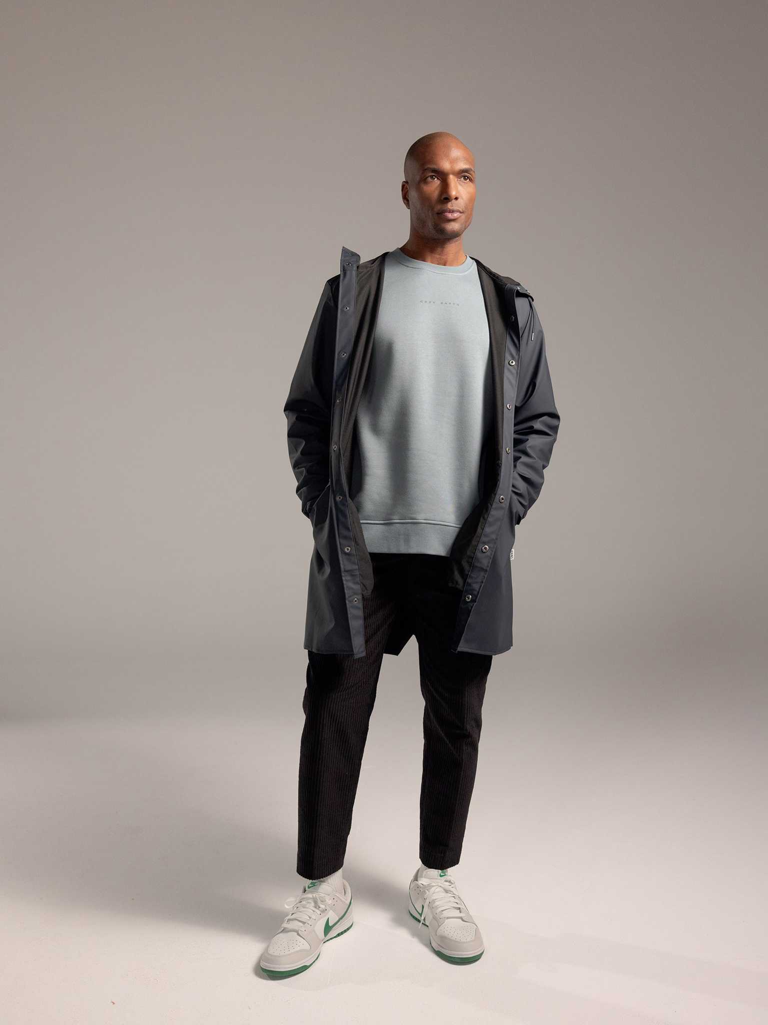 Man wearing Smokey Blue cityscape crewneck with grey background |Color:Smokey Blue