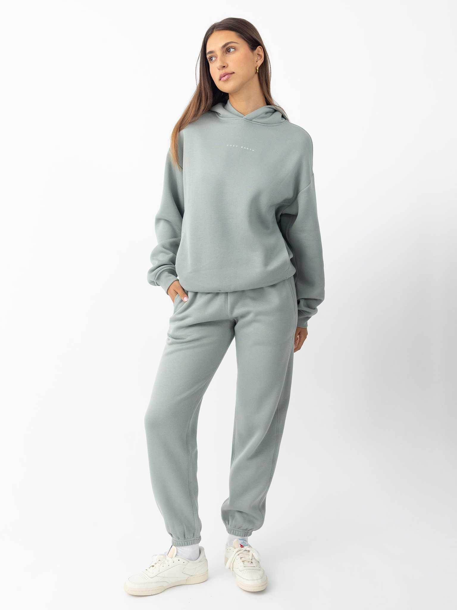 Woman wearing haze cityscape hoodie and sweats with white background |Color:Haze