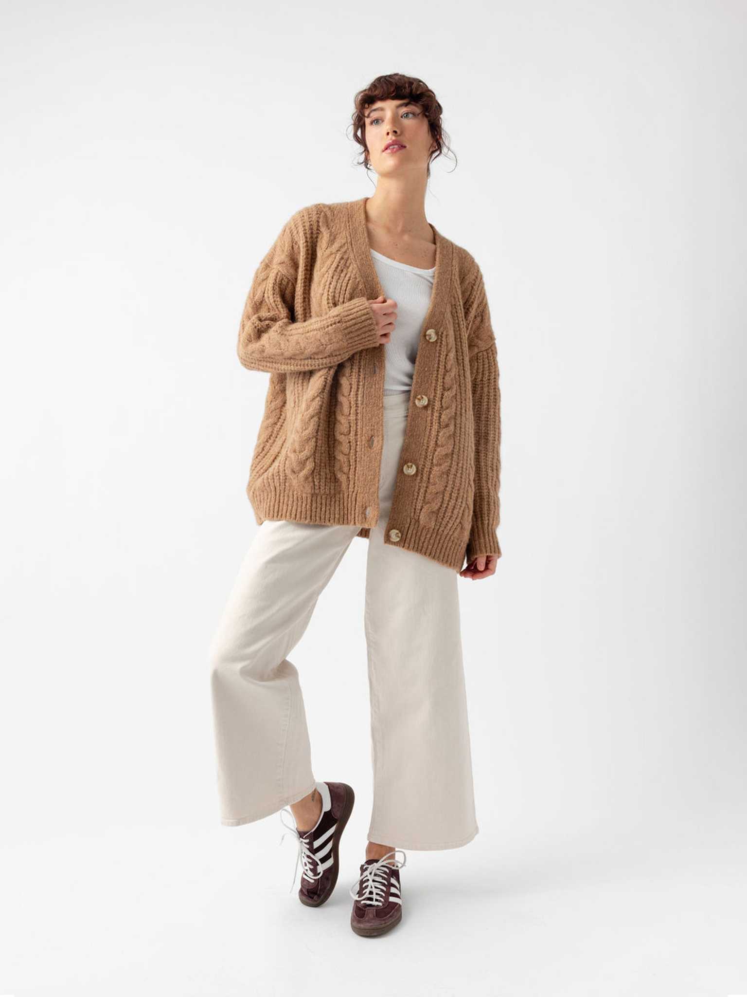 Studio image of woman in camel cardigan and off-white pants |Color:Camel