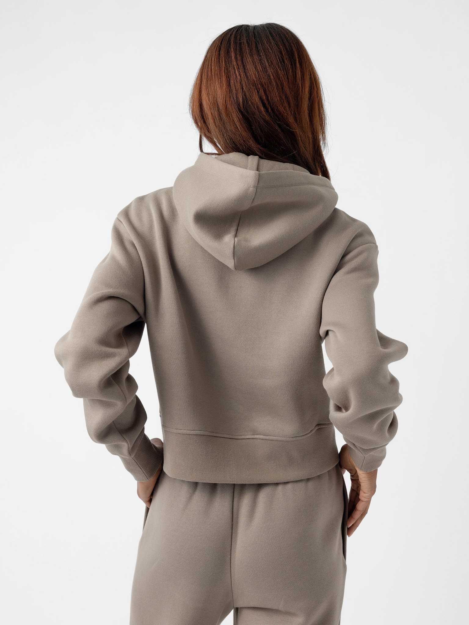 A person with long hair is shown from the back, wearing a light gray Women's CityScape Cropped Hoodie and matching sweatpants by Cozy Earth. The hoodie has a relaxed and casual style. The background is plain white. |Color:Ebony