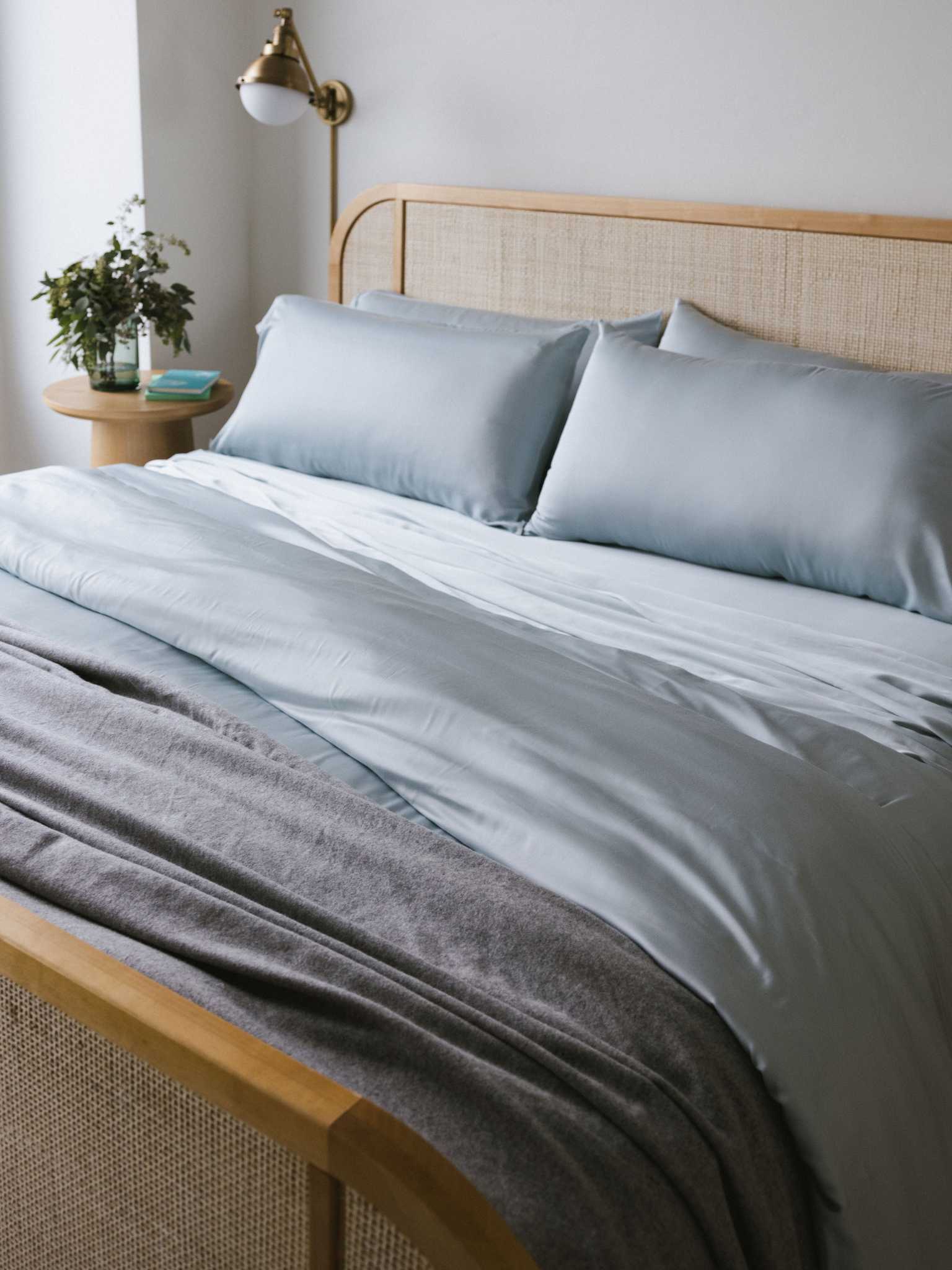 Partially made bed with shore bedding and cashmere blanket |Color:Shore
