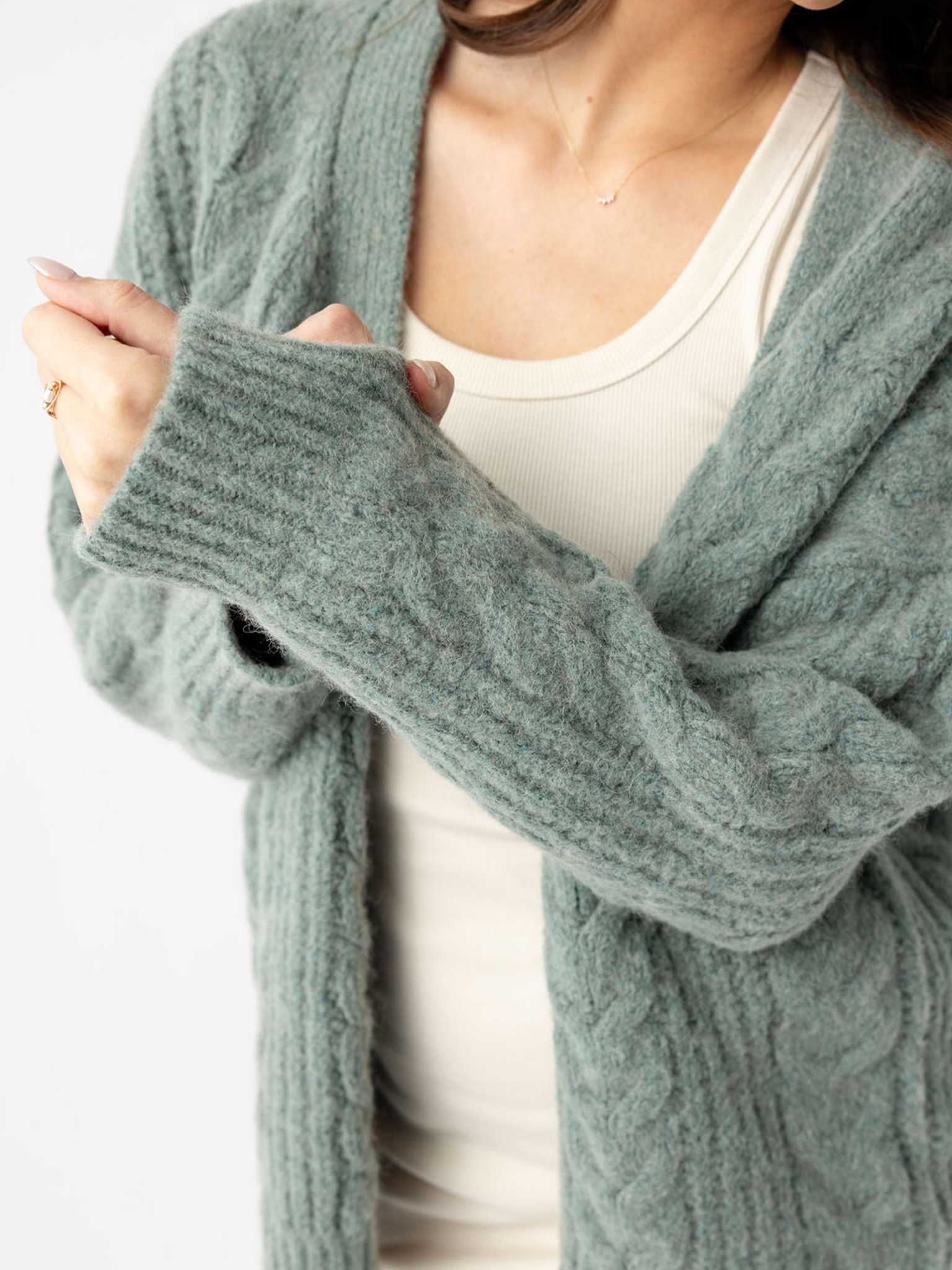Close up of woman wearing thyme cardigan over off-white dress |Color:Thyme