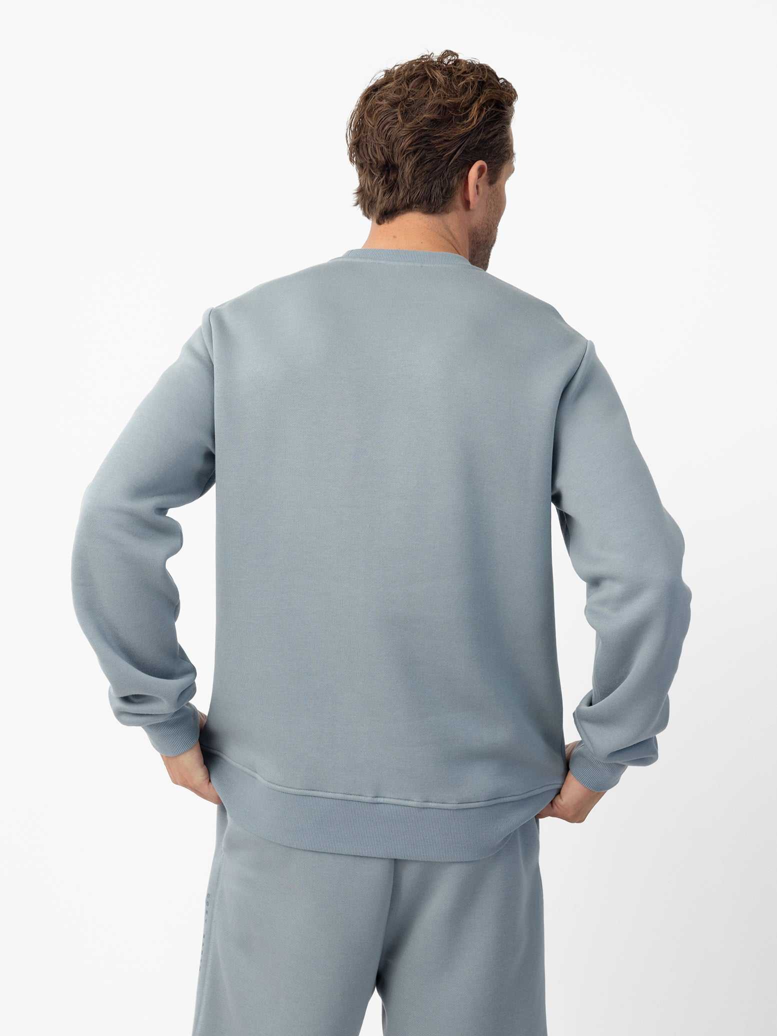 Man wearing Smokey Blue cityscape crewneck with white background |Color:Smokey Blue