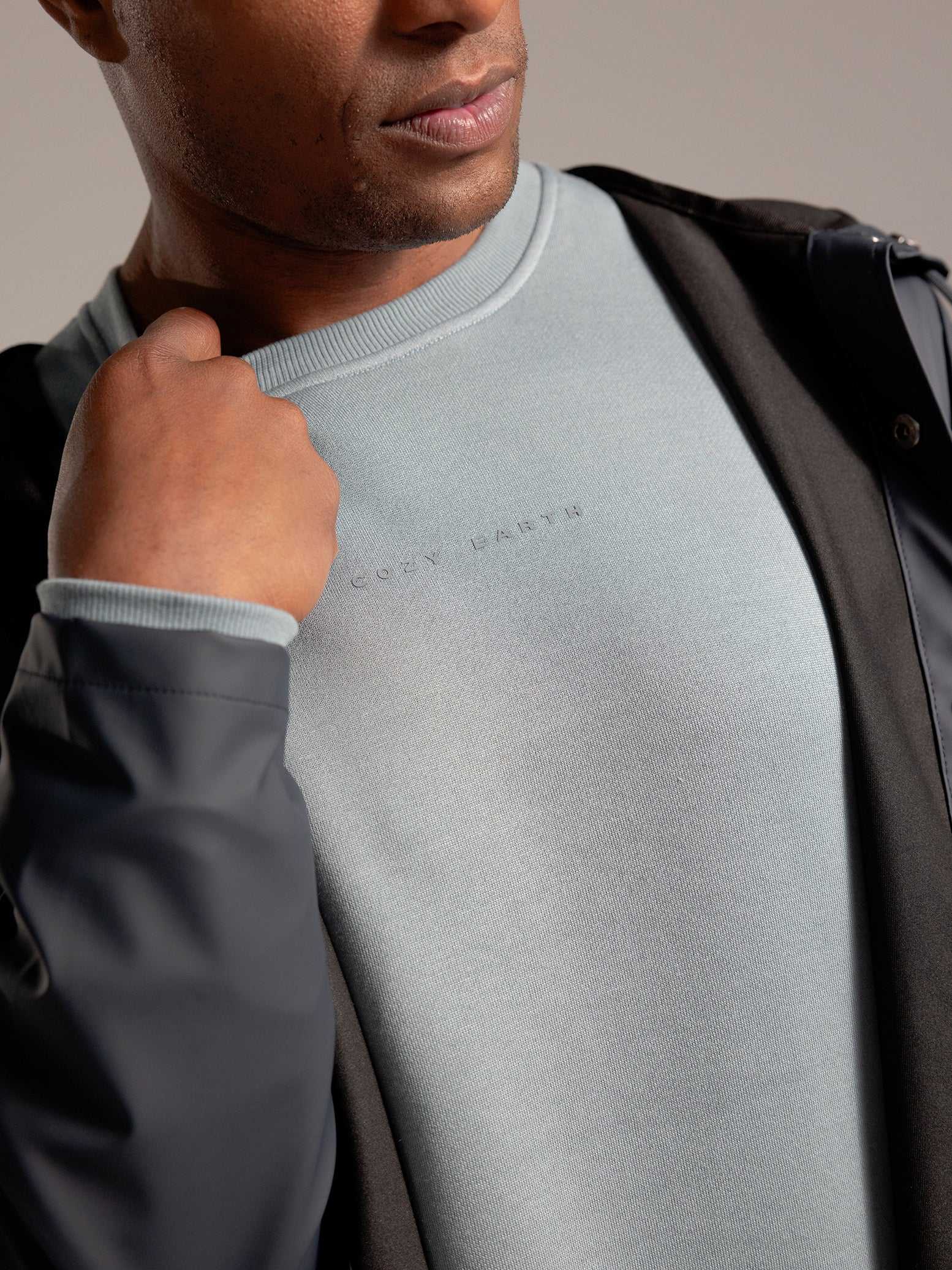 Man wearing Smokey Blue cityscape crewneck with grey background |Color:Smokey Blue