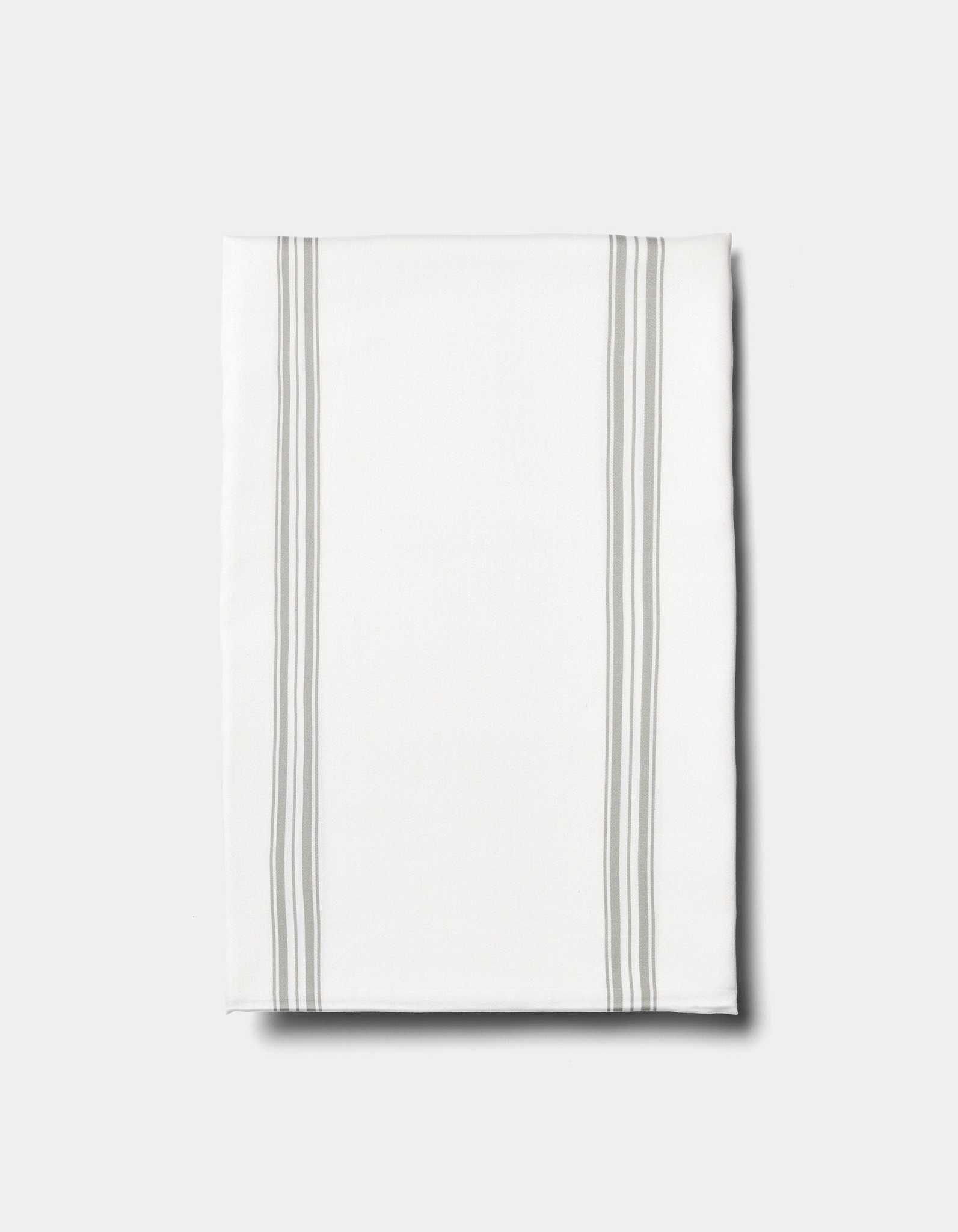 The Cozy Earth Bamboo Sheet Set is displayed on a plain light background, featuring neatly folded white fabric with two pairs of parallel light gray stripes running vertically near the edges.|Color:Baja Stripe in Laurel