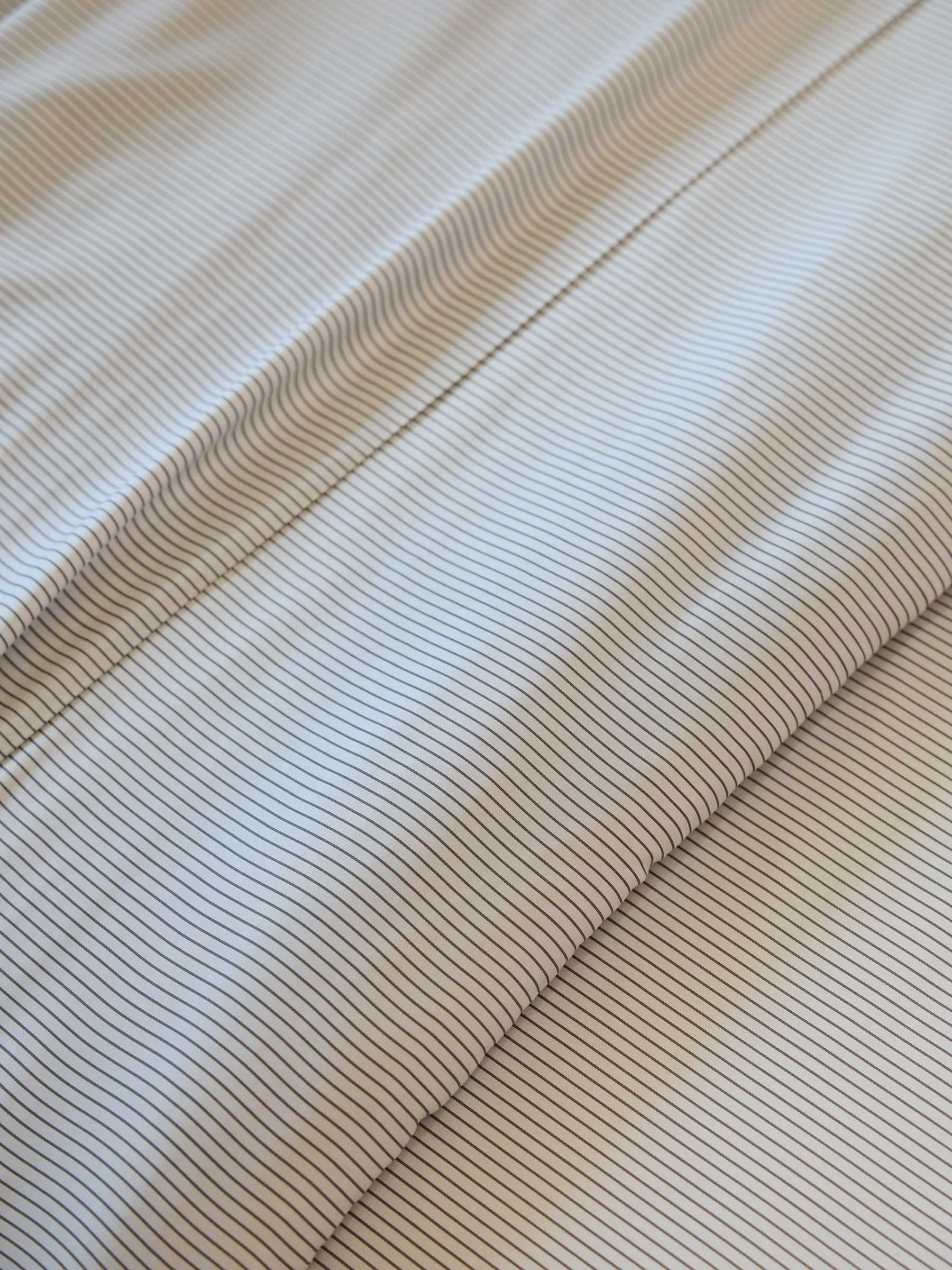 Cozy Earth's Bamboo Duvet Cover features a close-up design of thin, parallel lines that form a striped pattern. These evenly spaced lines create a textured and uniform appearance. |Color:Charcoal Pinstripe
