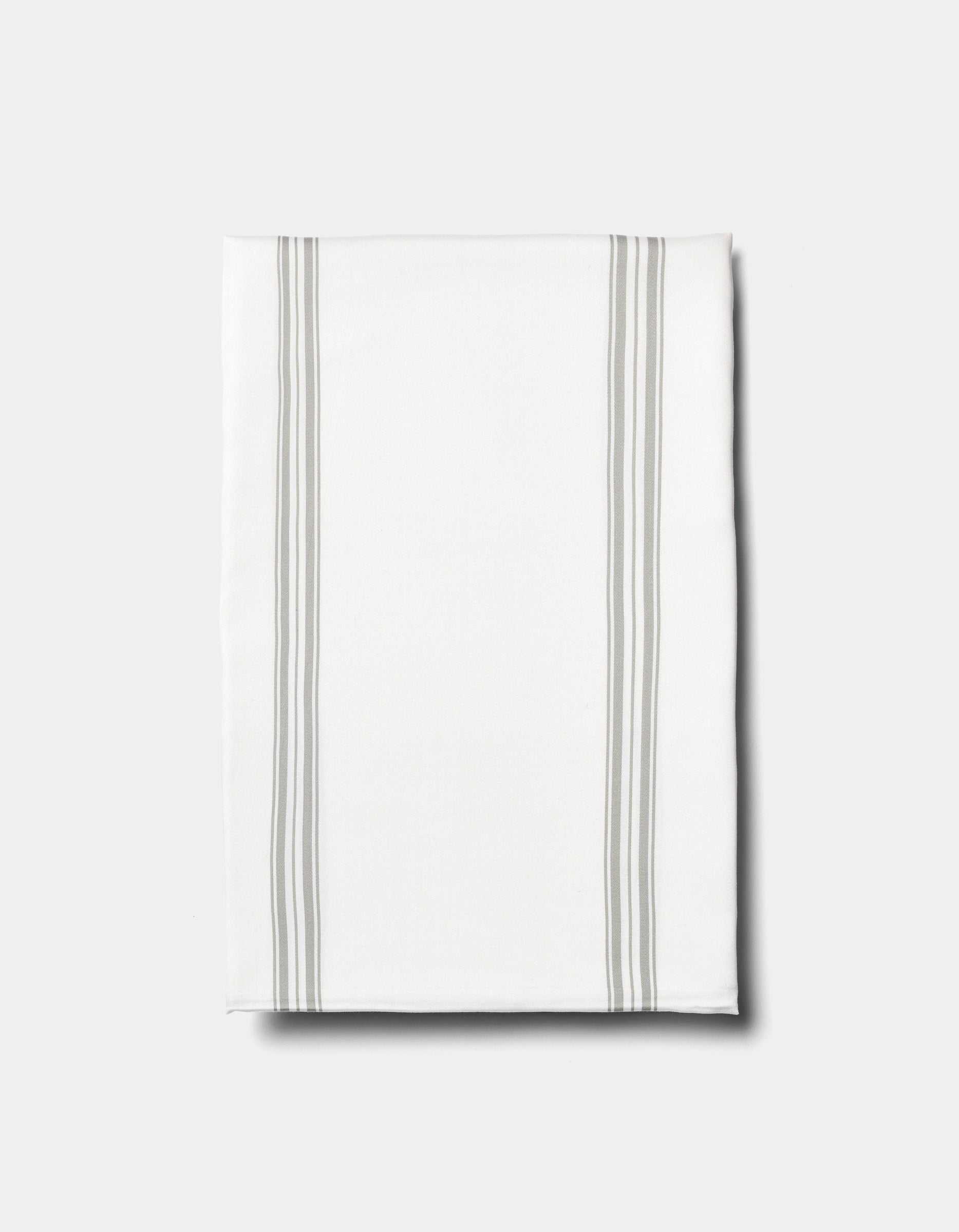 The Cozy Earth Bamboo Sheet Set is displayed on a plain light background, featuring neatly folded white fabric with two pairs of parallel light gray stripes running vertically near the edges.|Color:Baja Stripe in Laurel