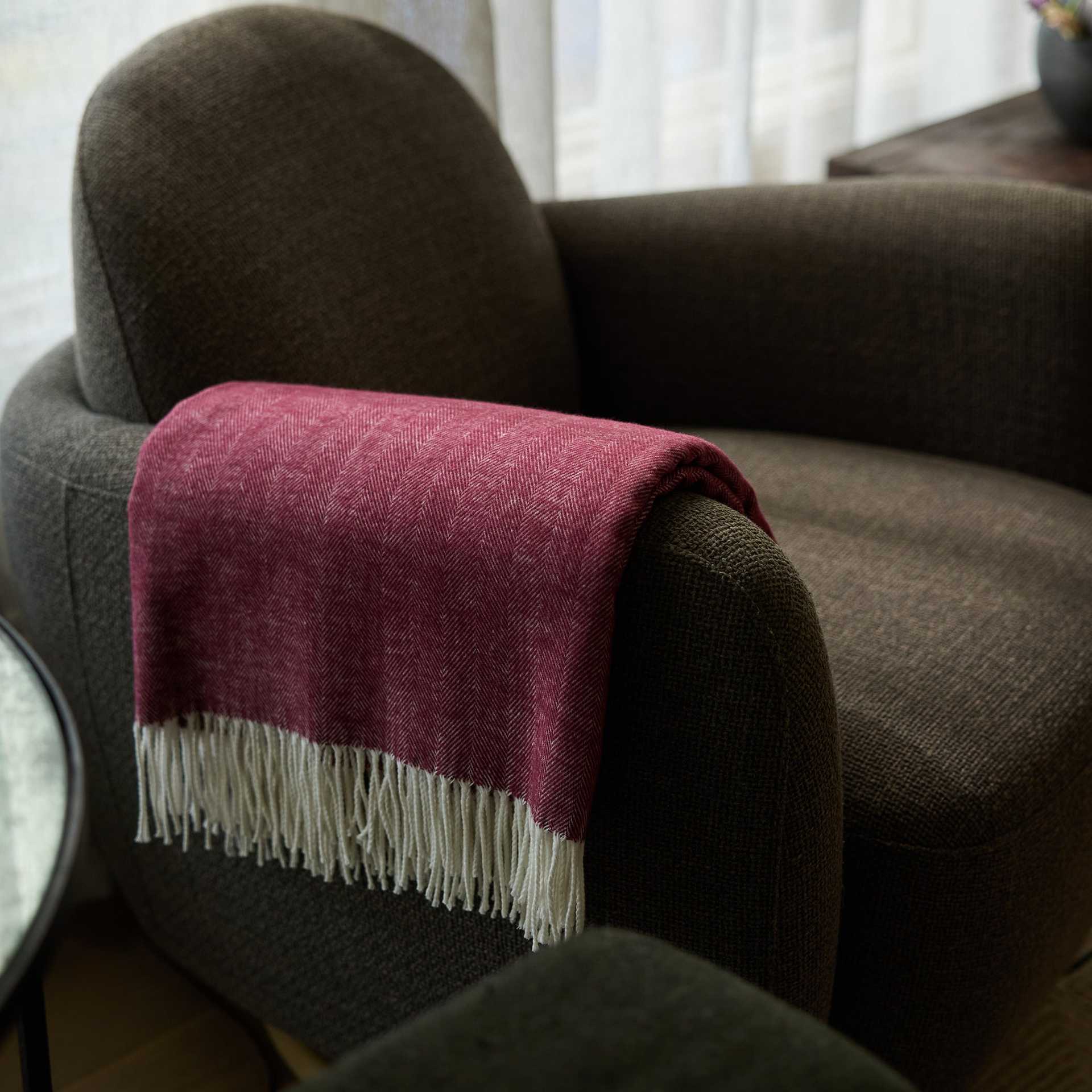Berry herringbone tassel throw draped over recliner |Color:Berry