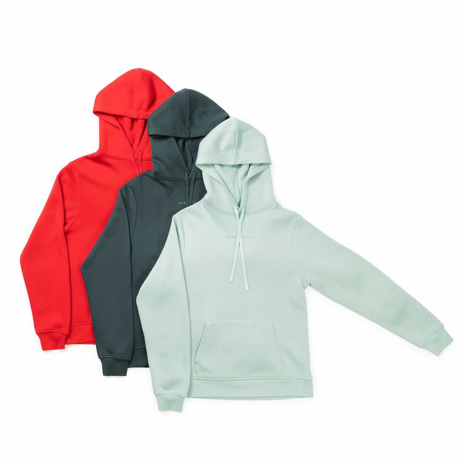 Three Men's CityScape Hoodies from Cozy Earth, available in red, dark green, and light green. Each features a front pocket and drawstrings on the hood. They are displayed side by side, presenting the front view. |Color:Crimson