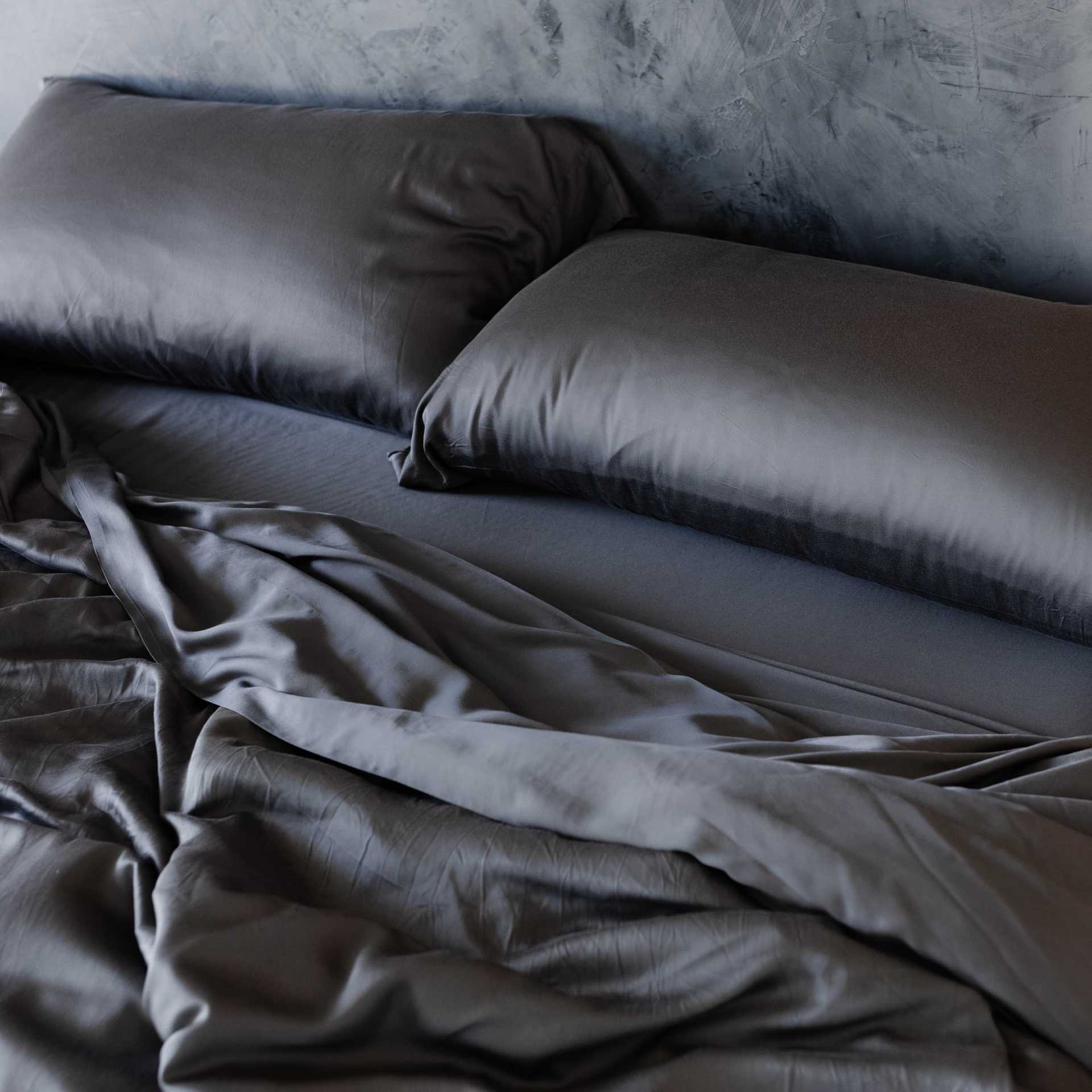 Unmade bed with charcoal bedding |Color:Charcoal