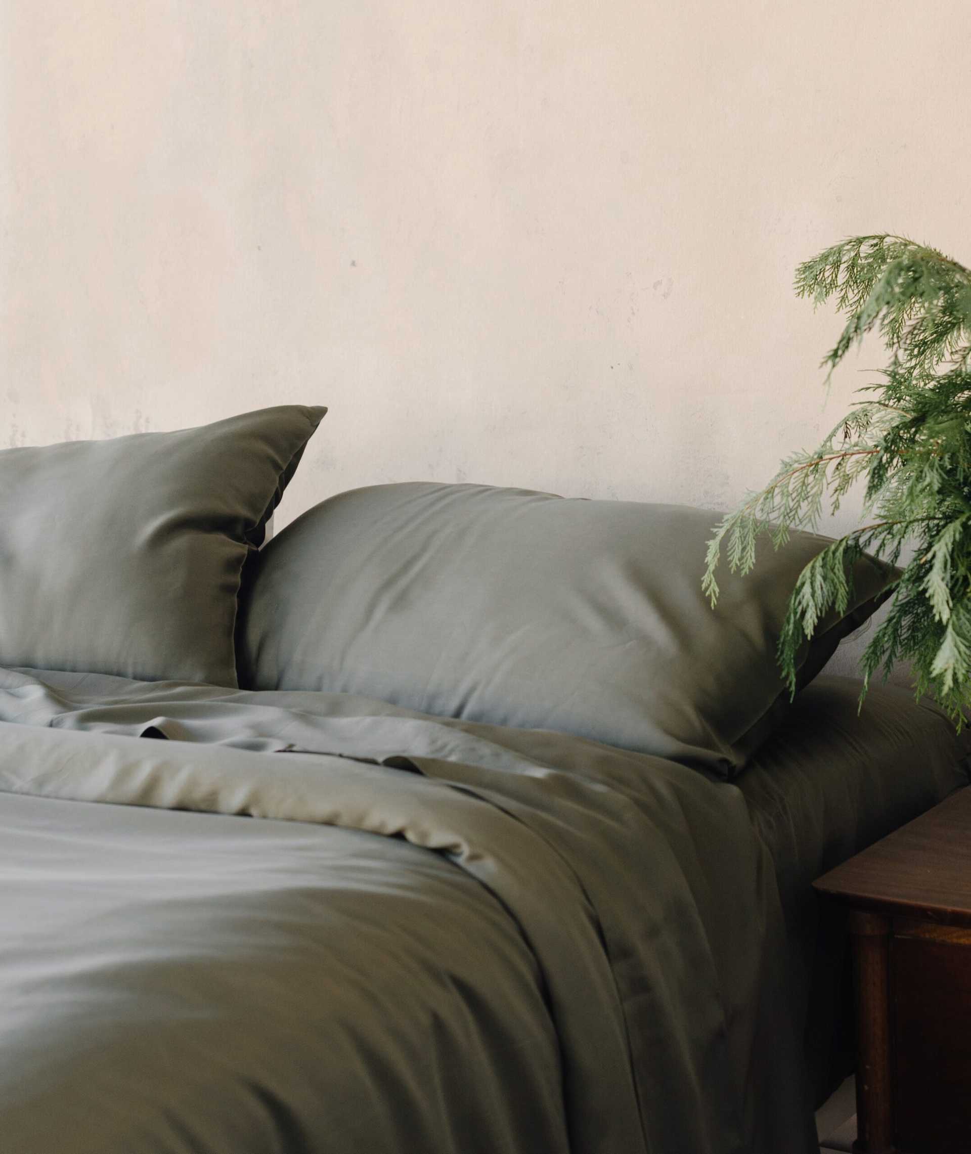 Bed with olive bedding and plant on the nightstand |Color:Olive