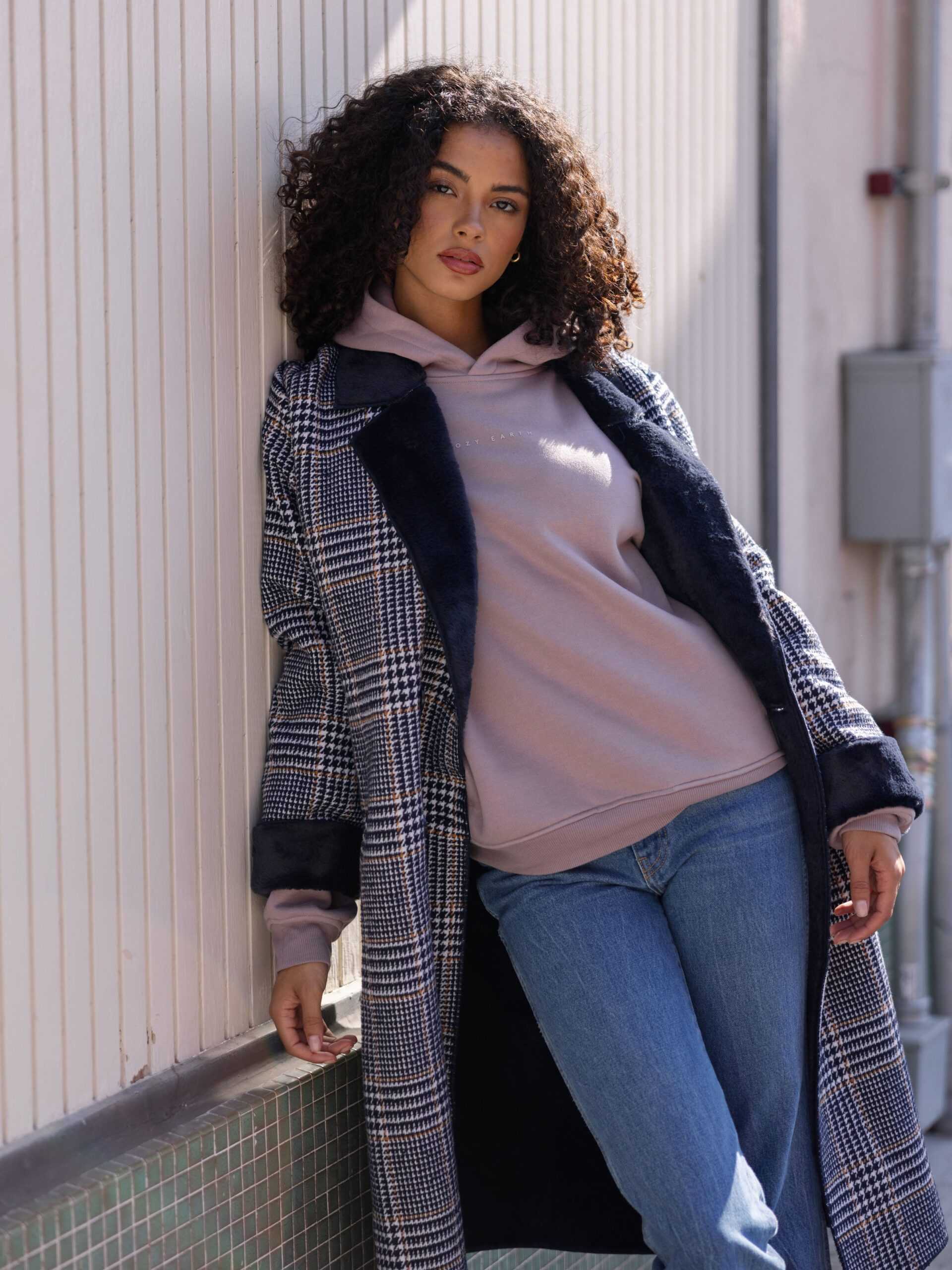 Woman wearing dusty orchid cityscape hoodie and overcoat outside |Color:Dusty Orchid