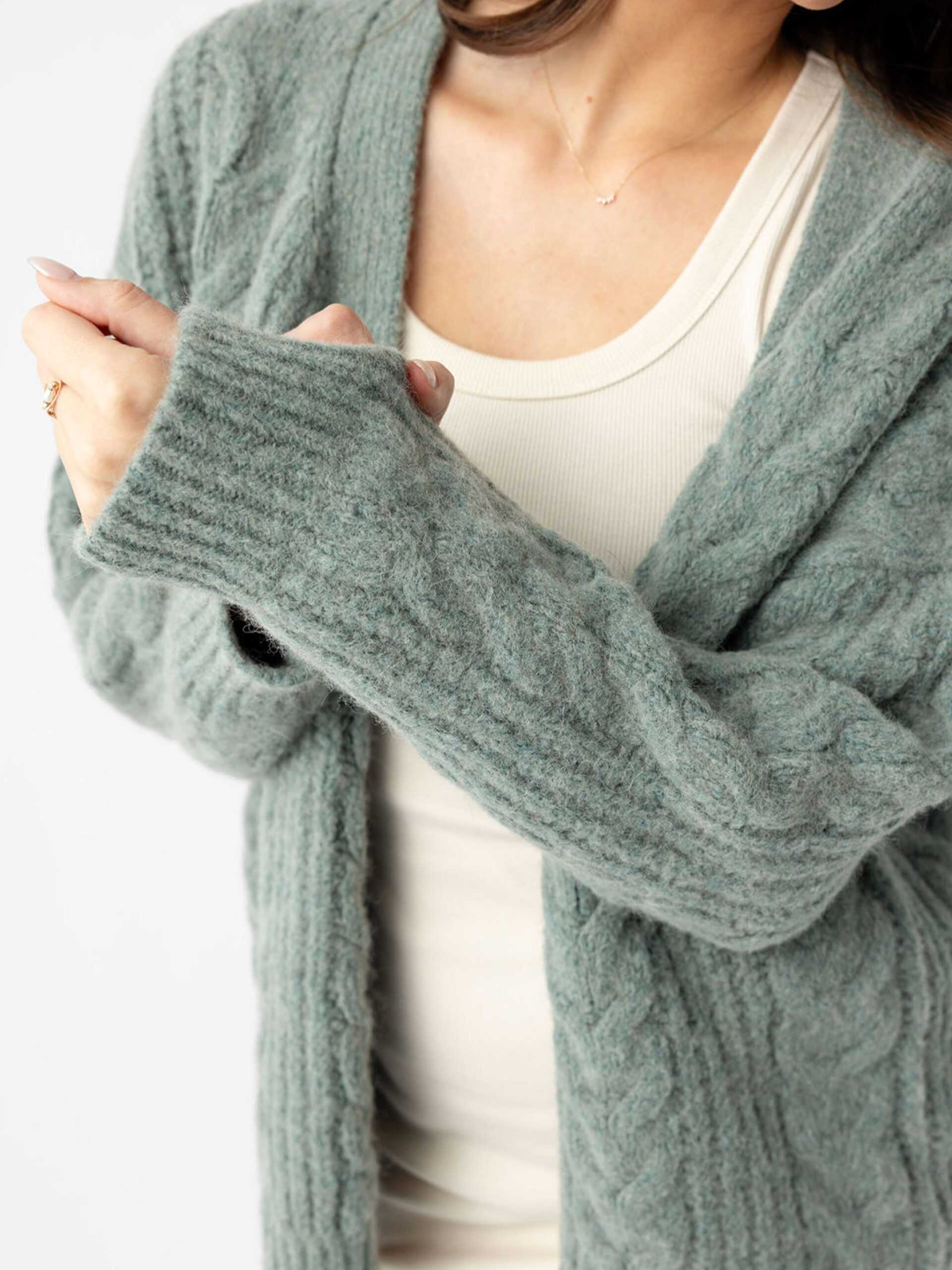 Close up of woman wearing thyme cardigan over off-white dress |Color:Thyme