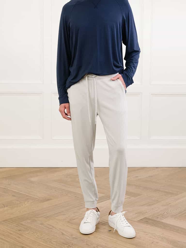 Light Grey/Navy Men's Bamboo Jogger Set. There is a man wearing the jogger set. He is standing in a well lit room in a home.|Color:Light Grey