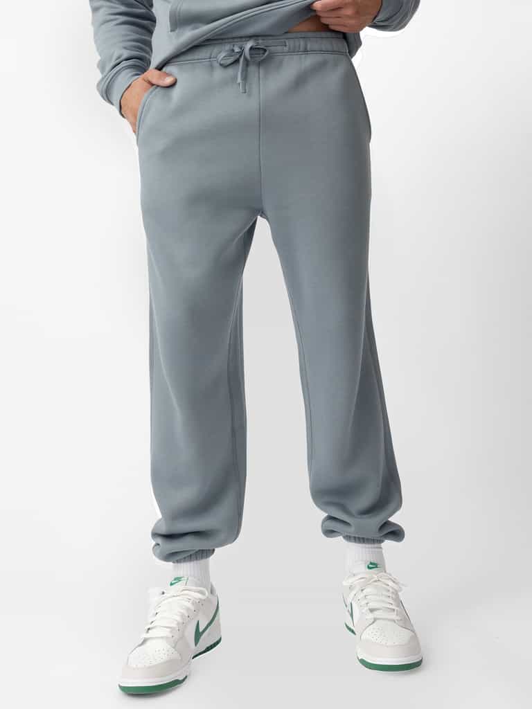 Man wearing smokey blue cityscape sweats with white background