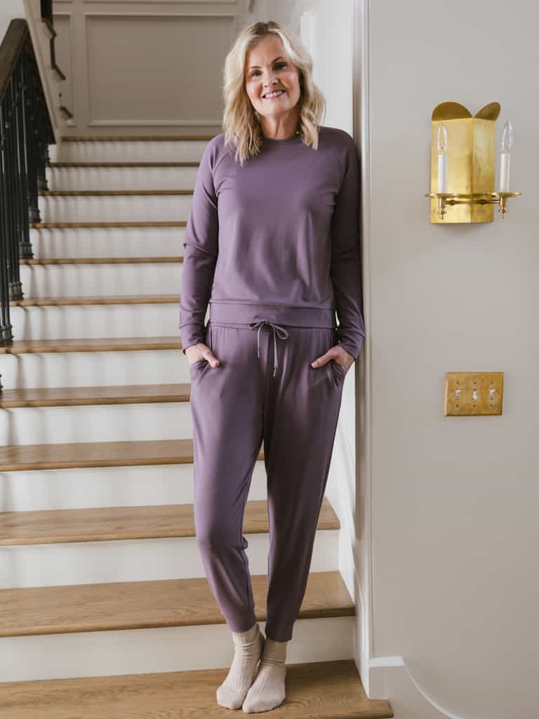 Twilight Bamboo Jogger Set modeled by a woman. The photo was taken in a high contrast setting, showing off the colors and lines of the pajamas. |Color: Twilight