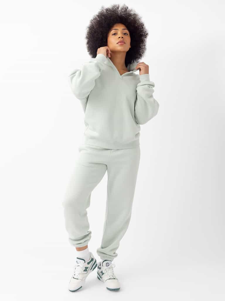 Arctic CityScape Joggers. The Joggers are being worn by a female model. The photo is taken with the models hand by the pocket of the joggers. The back ground is a crisp white background. |Color:Arctic