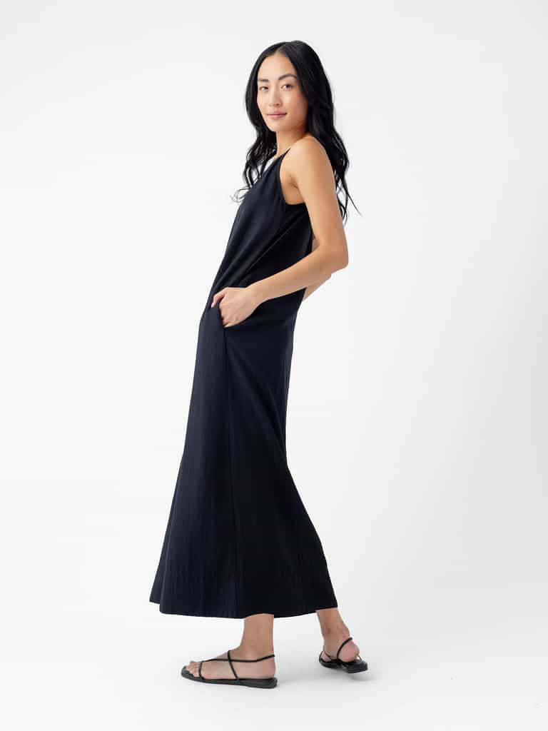 A woman in Cozy Earth's Women's Sunset Slip Dress. |Color:Jet Black