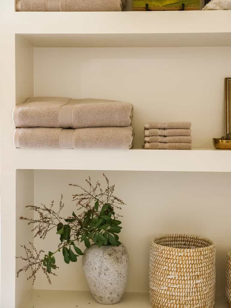 Sand luxe bath towels and washcloths folded on shelf |Color:Sand