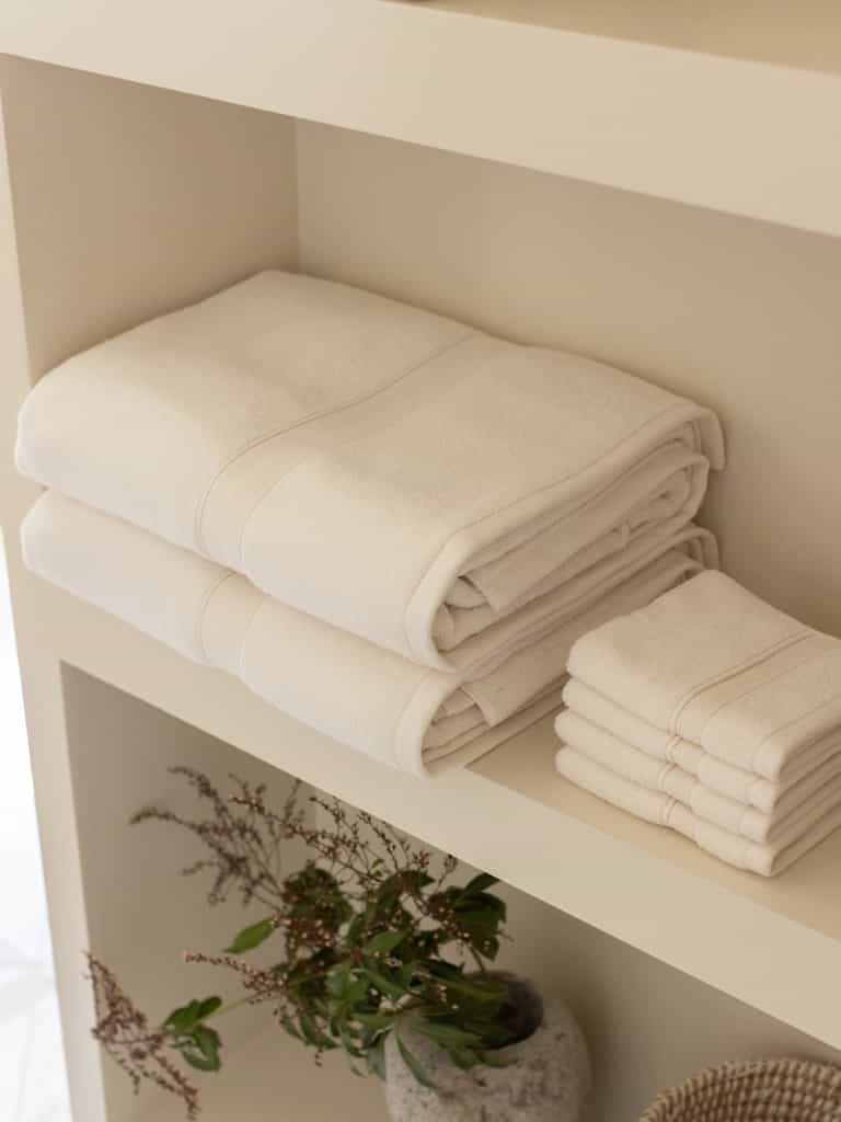 Seashell luxe bath towels and washcloths folded on shelf |Color:Seashell