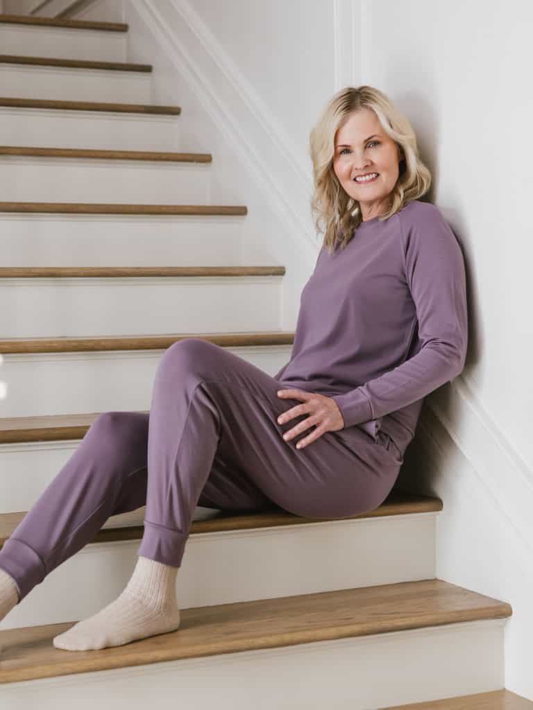 Twilight Bamboo Jogger Set modeled by a woman. The photo was taken in a high contrast setting, showing off the colors and lines of the pajamas. |Color: Twilight
