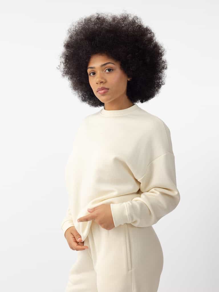 Woman wearing Alabaster CityScape Crewneck with white background |Color: Alabaster