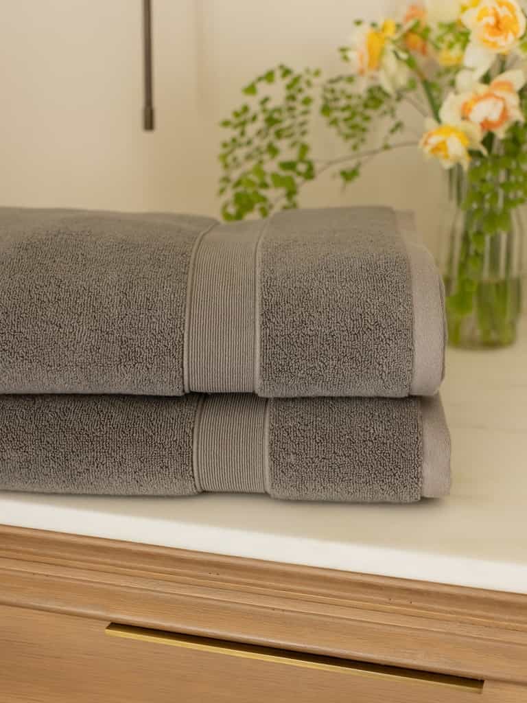 Charcoal luxe bath towels folded on bathroom counter |Color:Charcoal