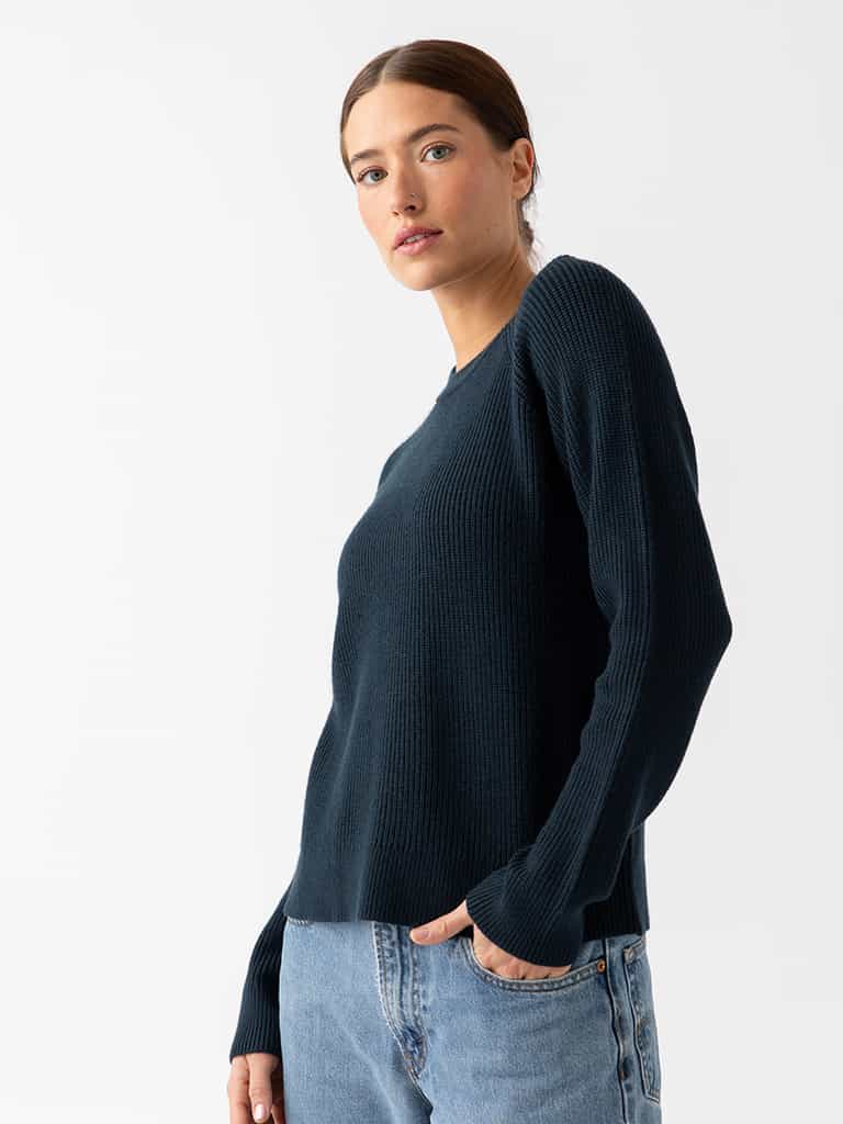 Woman waist up wearing eclipse classic crewneck and jeans with white background |Color:Eclipse