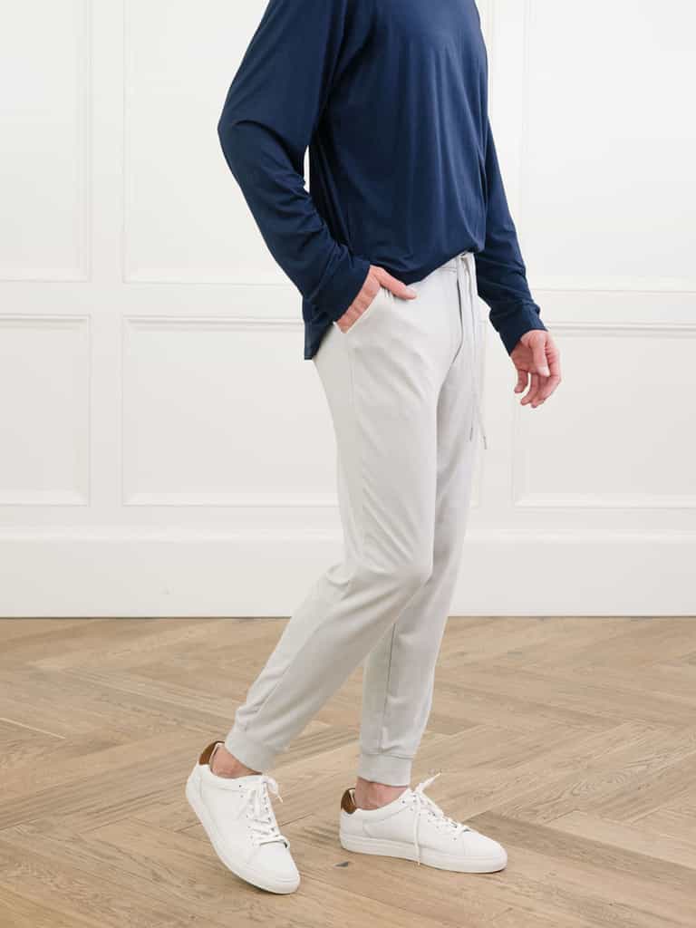 Light Grey/Navy Men's Bamboo Jogger Set. There is a man wearing the jogger set. He is standing in a well lit room in a home.|Color:Light Grey