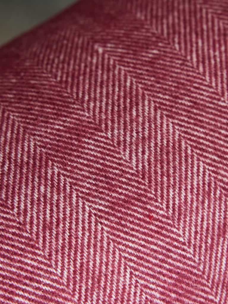 Close up of berry herringbone tassel throw |Color:Berry