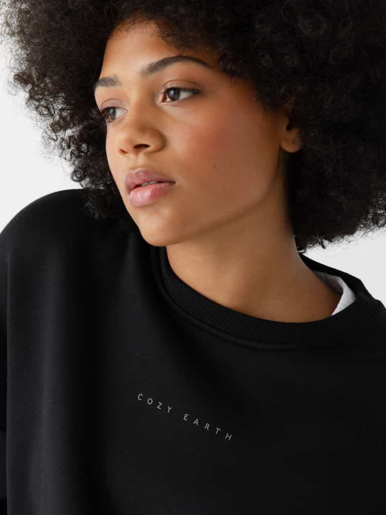Black CityScape Pullover Crew. The Pullover is being worn by a female model. The photo was taken with a white background. |Color:Black