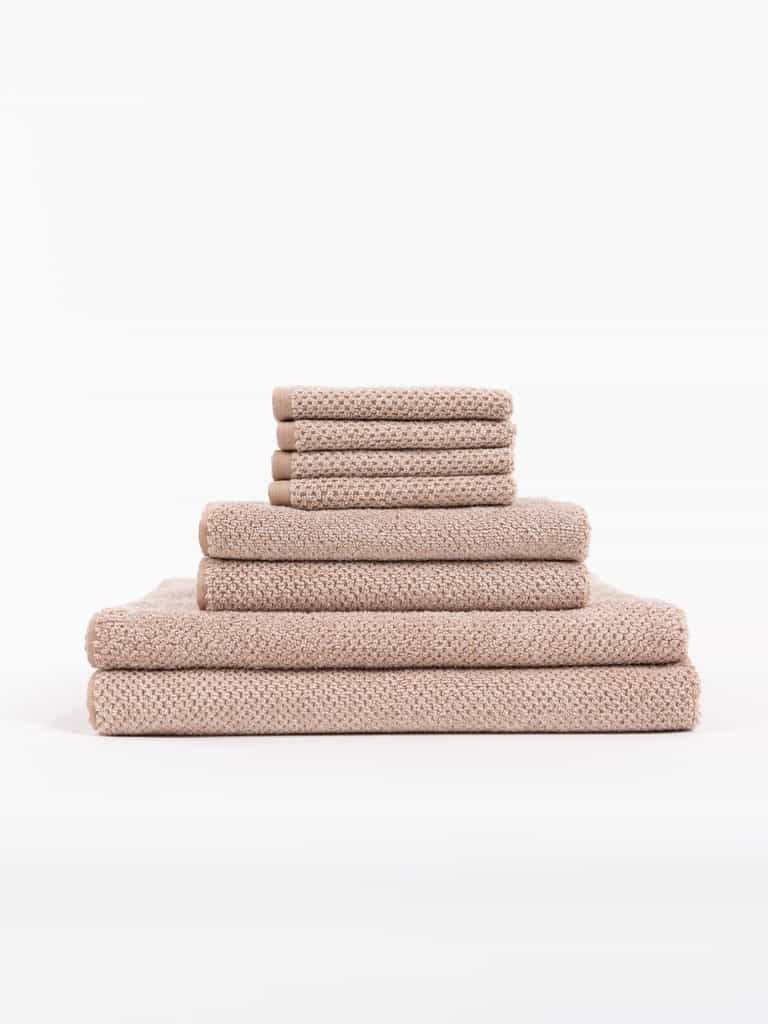 A stack of Nantucket Bath Towels sit in front of a white background. |Color:Heathered Clay