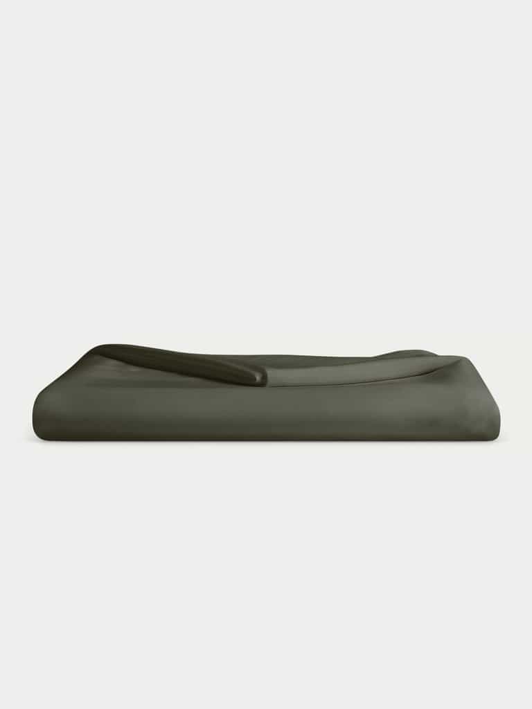 A neatly folded Bamboo Flat Sheet in dark green, by Cozy Earth, set against a light gray background. |Color:Olive
