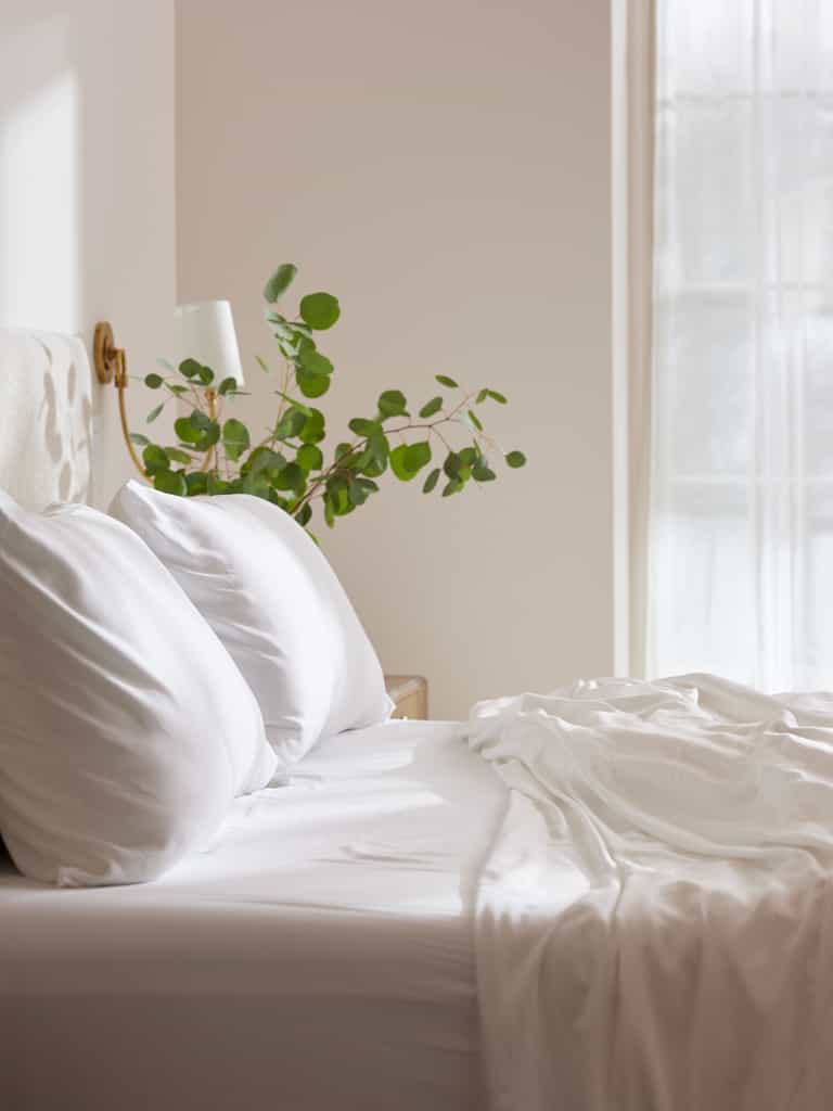 Side view of white bedding on an unmade bed |Color:White