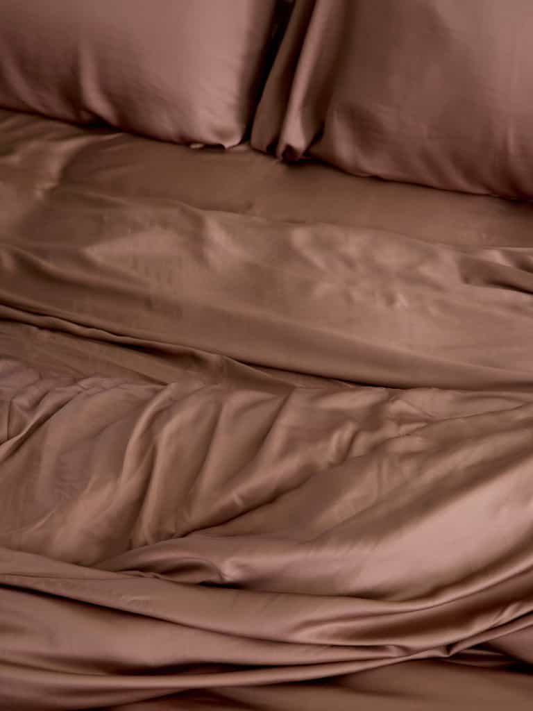 Close up of clay bedding on an unmade bed |Color:Clay