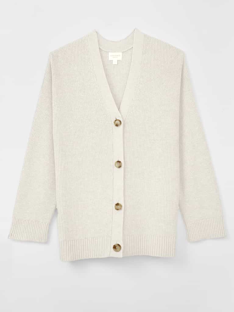 A woman wearing Cozy Earth Classic Cardigan is pictured on a white background |Color:Ivory