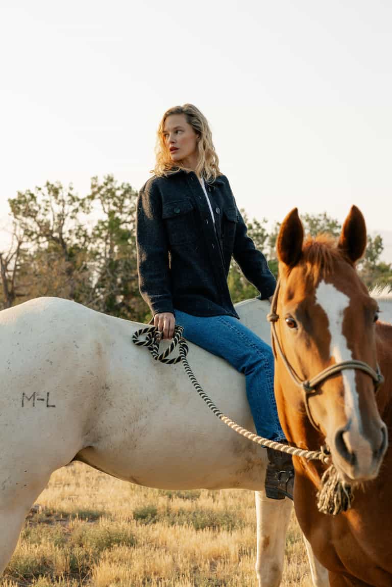 Woman in coal colored shacket riding white horse |Color:Coal