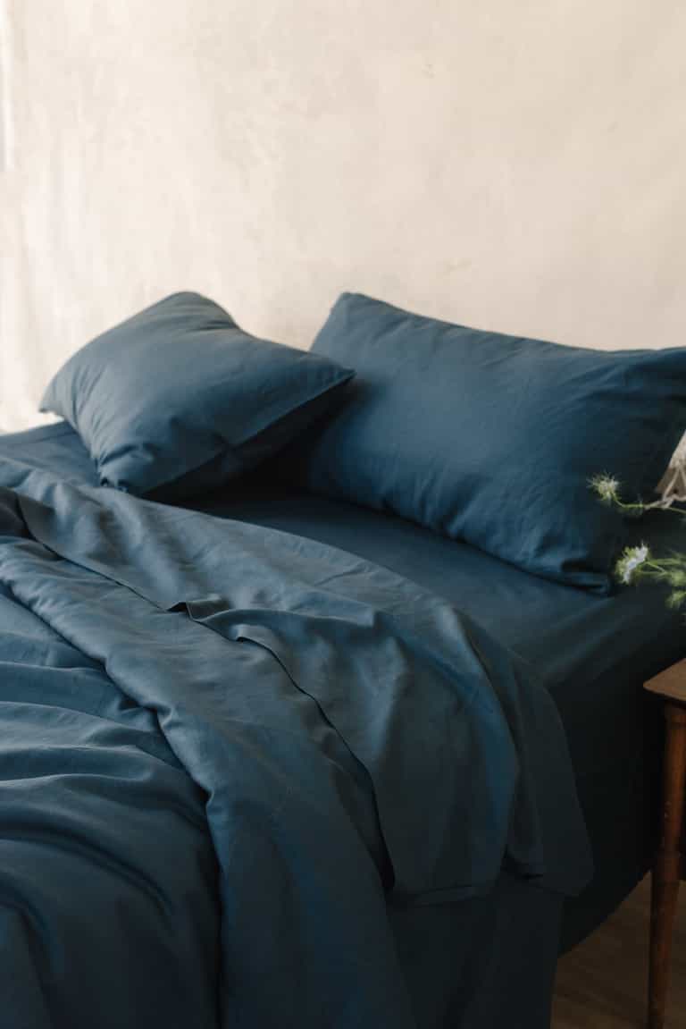 Navy Bamboo Linen Pillow Cases on a navy bed. |Color: Navy