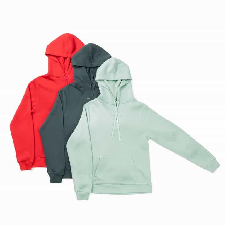 Displayed in the scene are three Cozy Earth Men's CityScape Hoodies, arranged with a light green hoodie at the forefront, a dark green one in the center, and a red one towards the back. Each hoodie is designed with a front pocket and drawstrings, and they slightly overlap each other. |Color:Wintergreen